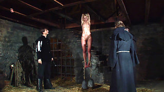 Blonde Girl Has Weights Attached to Her Feet and Is Hoisted up for Whipping