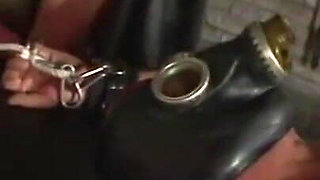 Humiliating man in gas mask