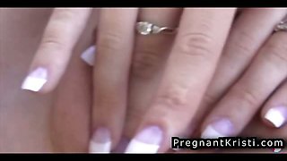 Horny pregnant girl masturbates her cunt while sitting on
