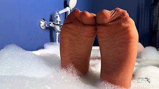 Scratching Mistress's Nylon Feet with a Scratcher in a Foam Bath