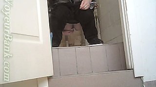 White chick in ugly baggy black pants pissing in the toilet