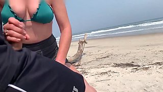 Busty MILF In Green Bikini Handjobs Her Partner On A Public Beach