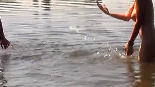 A beautiful busty brunette invites her boyfriend to fuck in the lake.