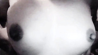 A girl roughly fondles her large breasts