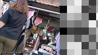 Ass young Arab woman with curly hair and olive jeans