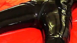 Oil body in latex catsuit