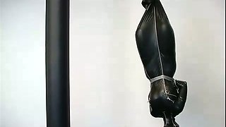 A bitch in latex overall gets suspended in BDSM scene